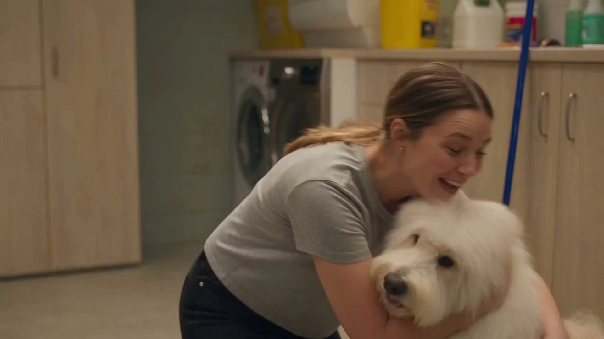 An owner greeting her newly groomed dog at Mophead